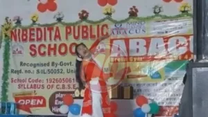 Child dancing on stage at school event.