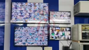 Multiple security monitors showing surveillance footage.