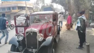Vintage car on street with people nearby