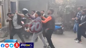 Group of men involved in street altercation.